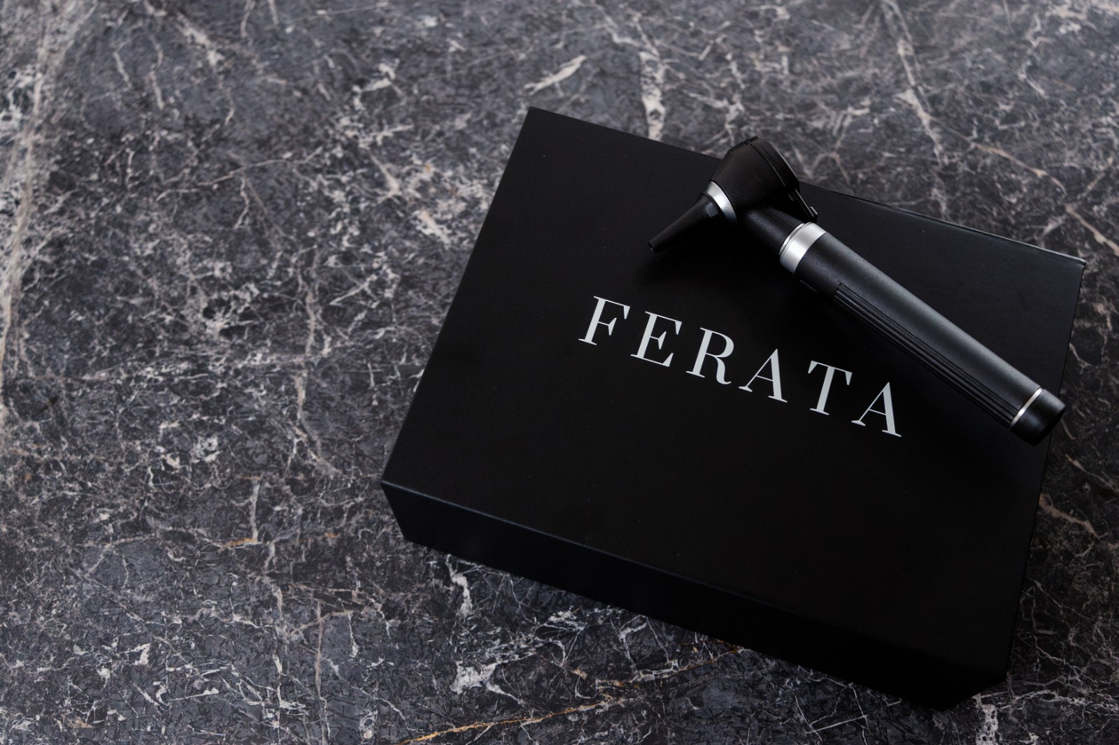 FERATA presentation case with clinical instrument on marble
